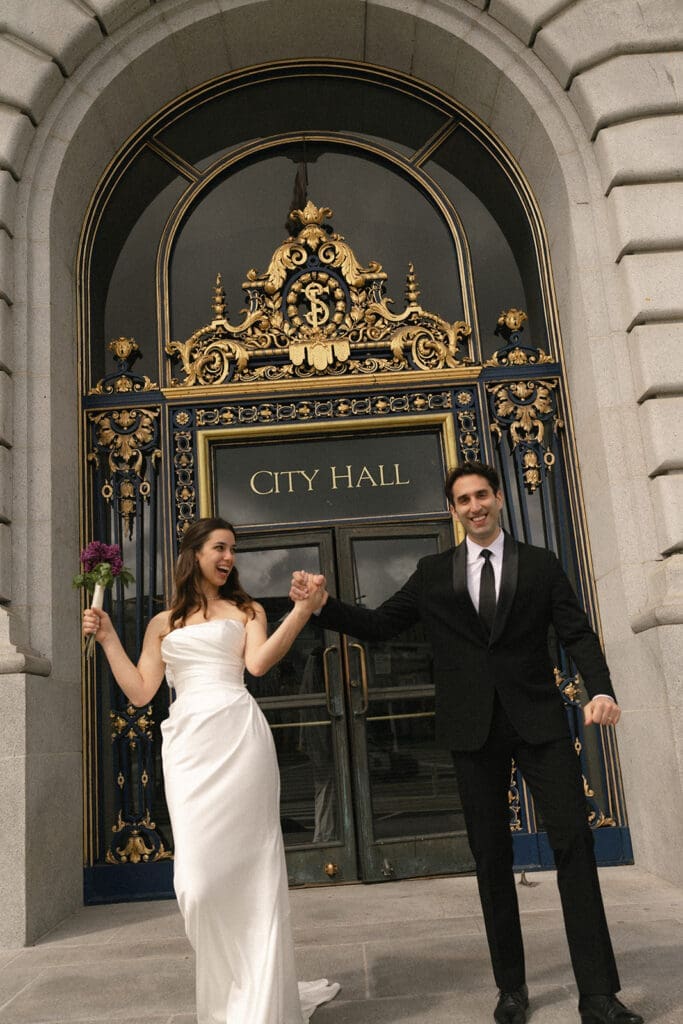 Bride and groom exit San Francisco city hall 