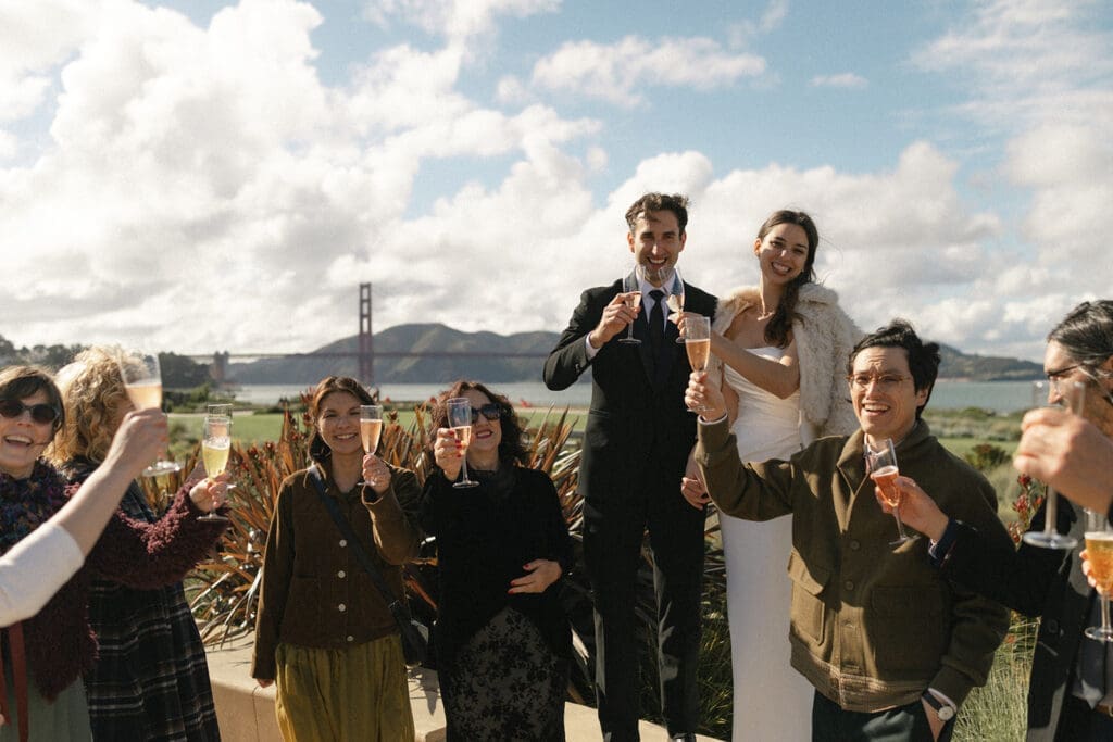 Bride and groom toast with guests at Presidio Tunnel Tops