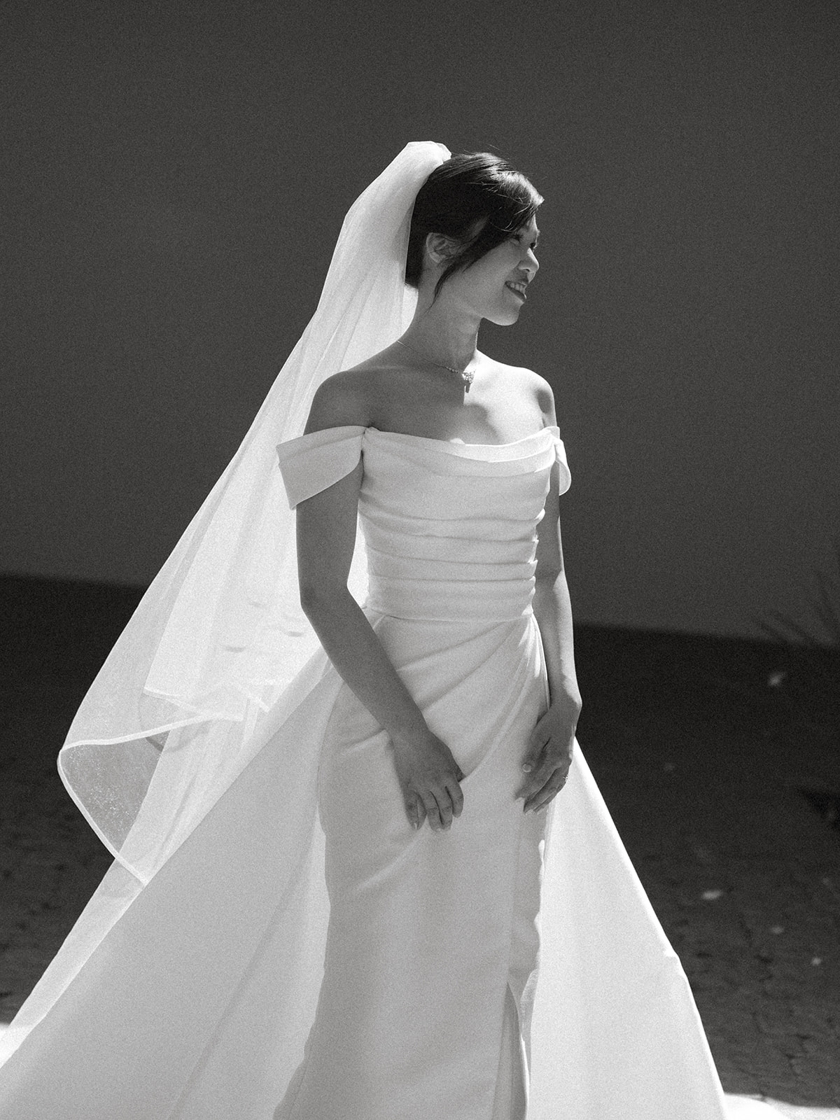 Bride in an off-the-shoulder wedding gown and flowing veil during bridal portraits at casa real at ruby hill winery, captured by a bay area wedding photographer.