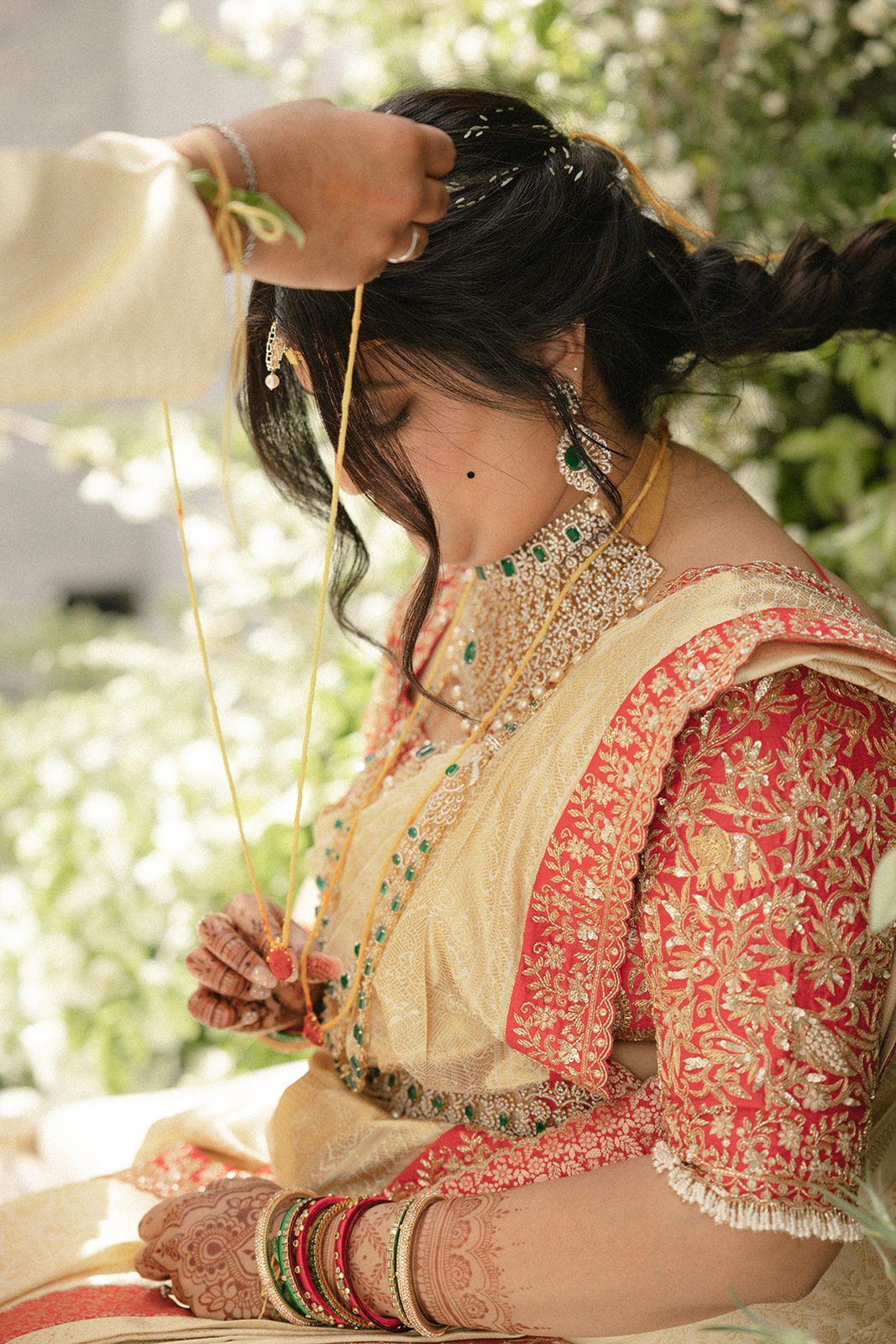 Bride in a gold and red sari during a traditional Indian wedding ceremony, photographed by a San Francisco wedding photographer.