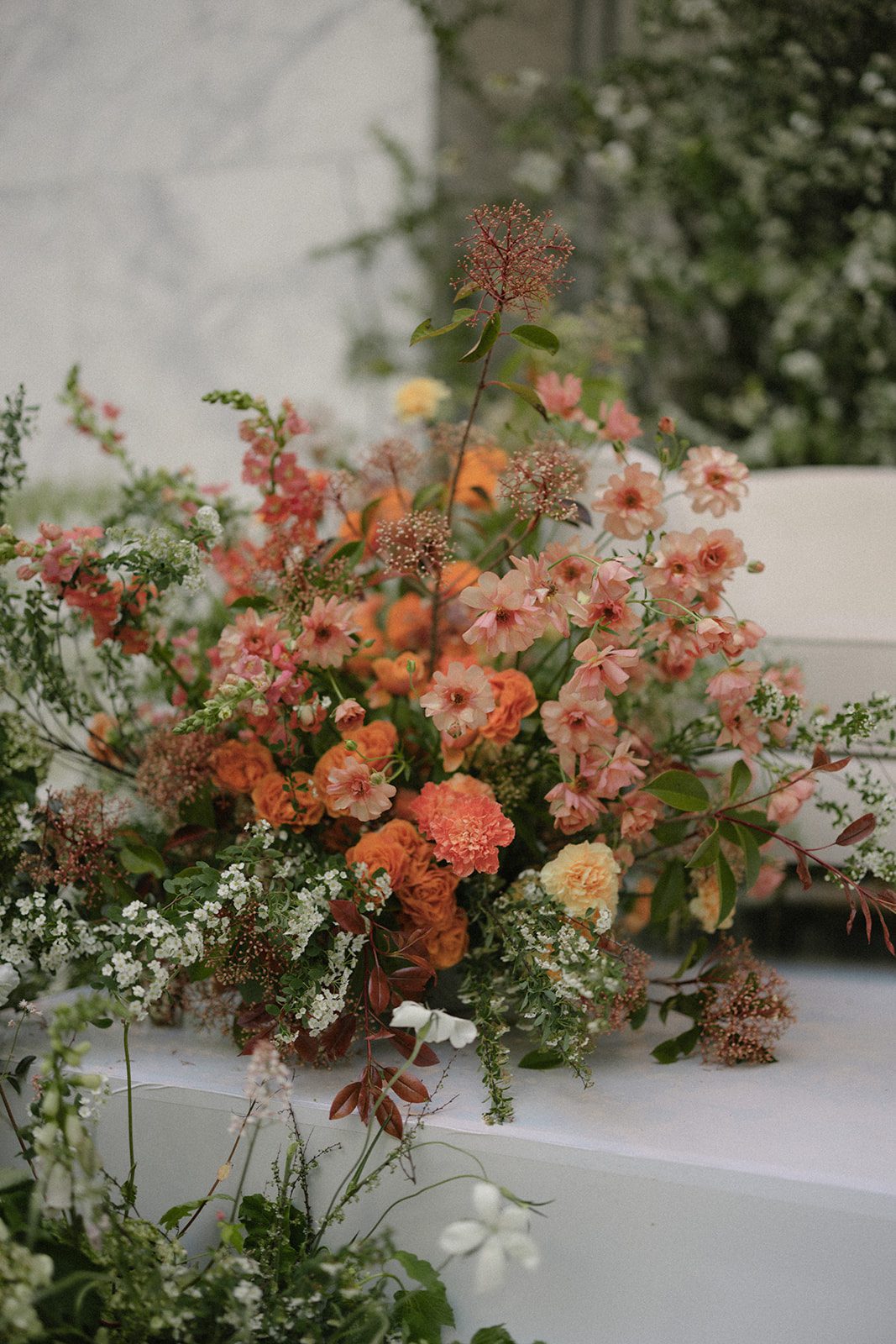 Coral, peach, and white floral arrangement decorating the reception space for The Conservatory at One Sansome wedding.