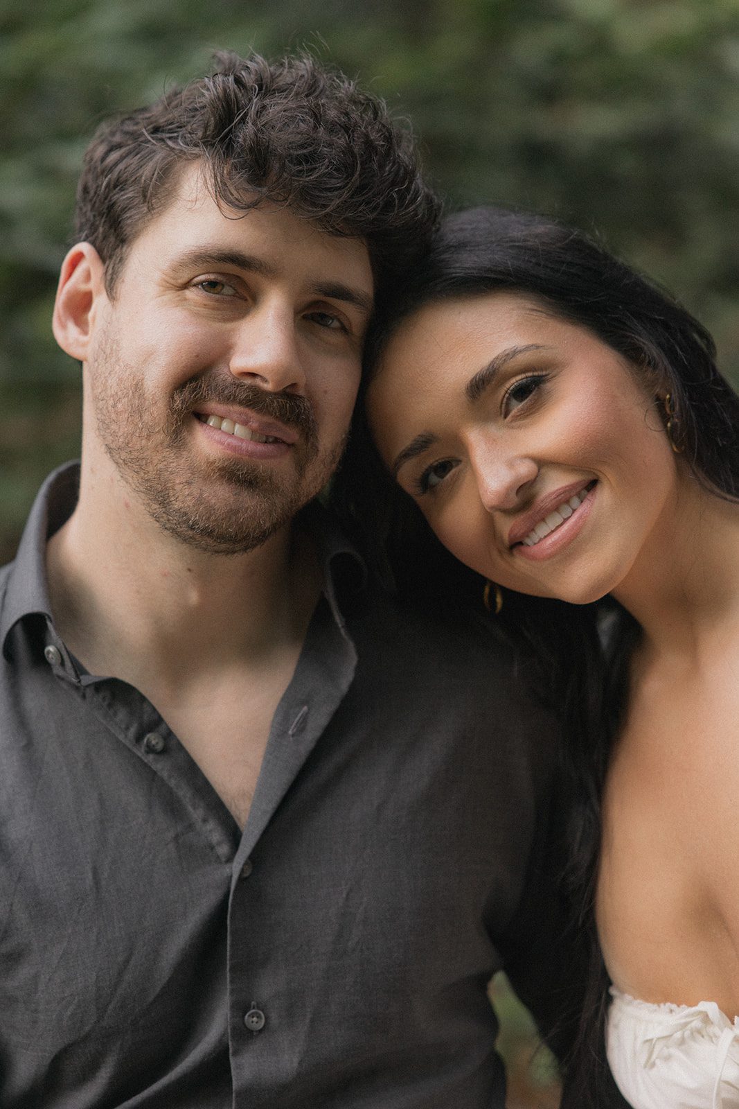Close-up portrait of an engaged couple leaning their heads together during forest engagement photos captured by a Bay Area wedding photographer.