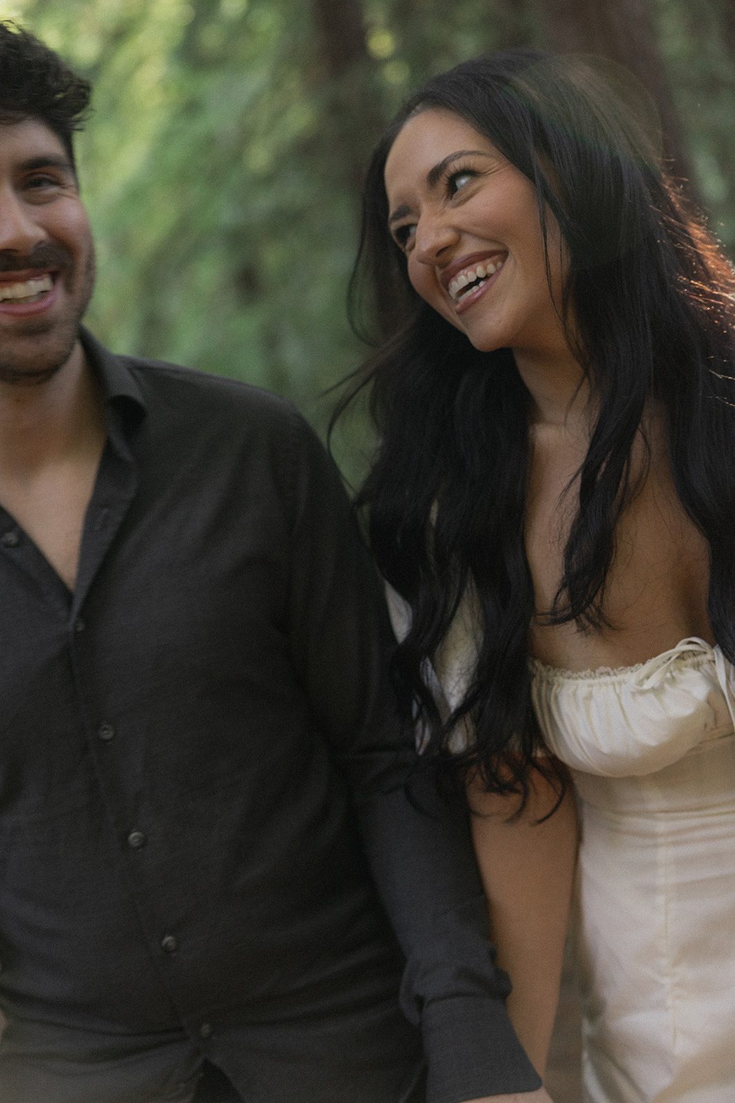 Close-up of an engaged couple laughing together among the trees, photographed by a Bay Area wedding photographer during their forest session.